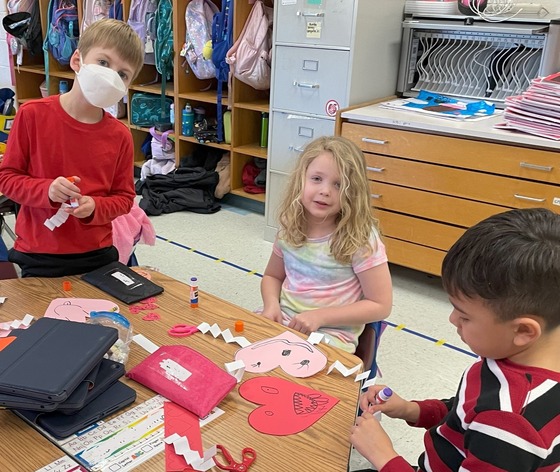 Students making Valentine crafts