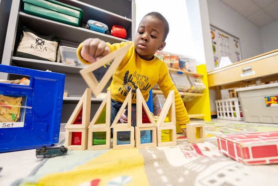 student plays with building block toys