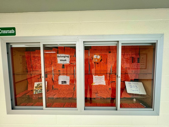 An image shows a display case with orange papers AKA "Belonging Spots"