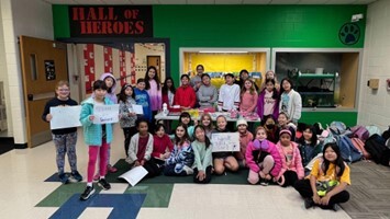 photo of a group of girls at Oakton ES holding appreciation signs