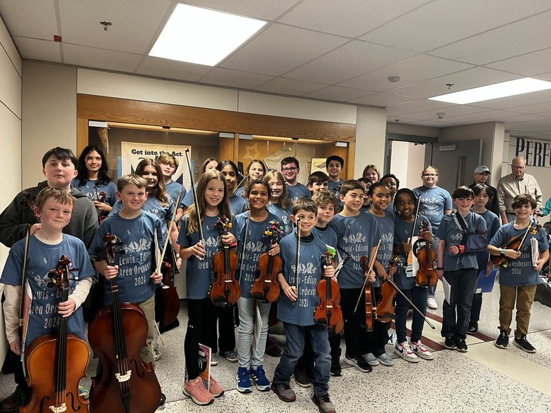 Clermont Area Orchestra students pose with their instruments.