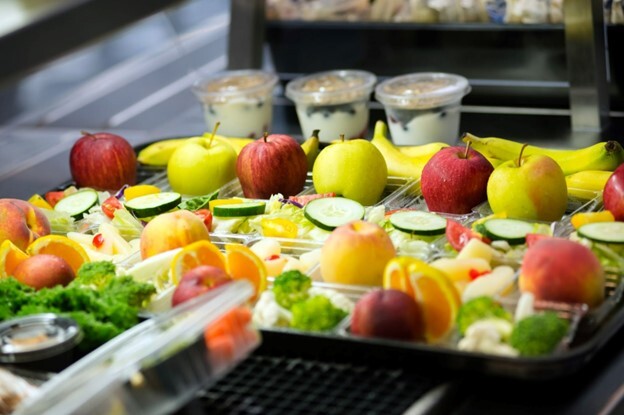 photo of fruits and vegetables on lunch trays