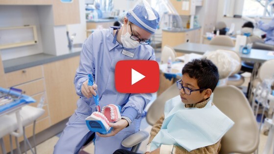 Dental student sitting with child