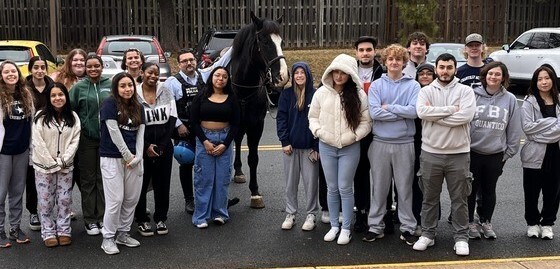 Students standing with horse