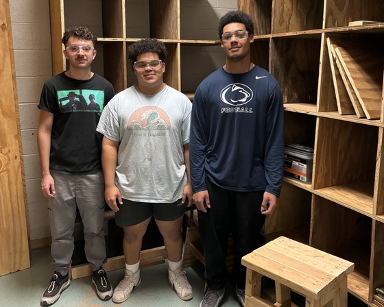 Carpentry students with their custom shelving