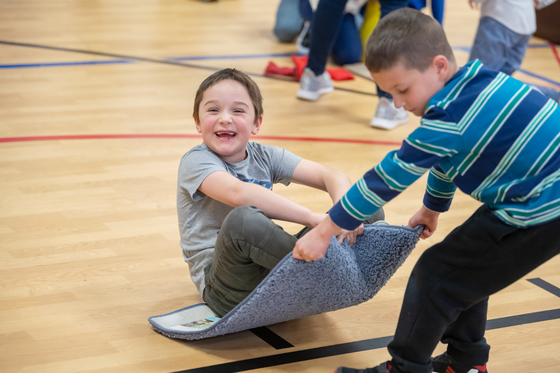 two students playing on an indoor basketball court