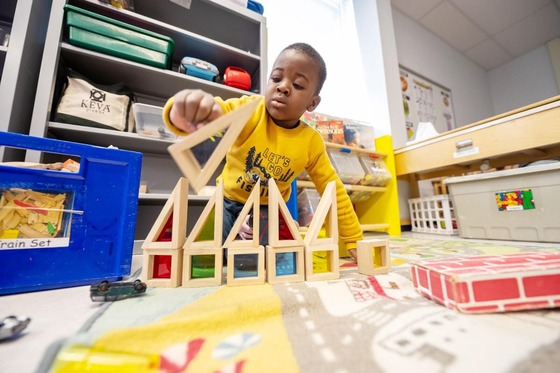 student playing with building blocks