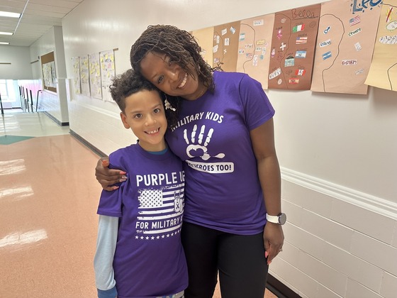 Ms. Usher and her son pose on PurpleUp day