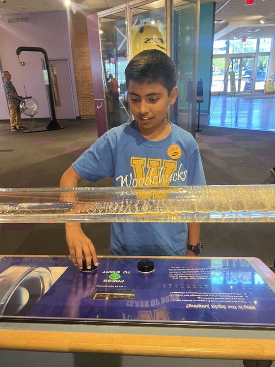 A student learning at a  science museum exhibit