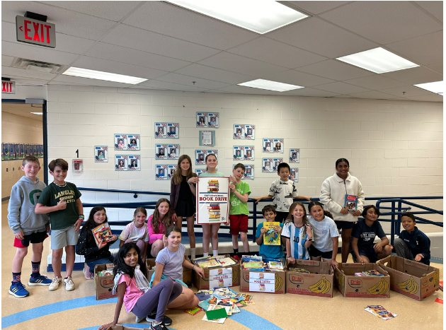 Students pose with boxes of donated books