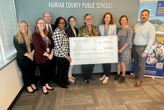 FCPS Superintendent Reid, Educate Fairfax Executive Director Henry and others receive a donation from I-66 Express Mobility Partners
