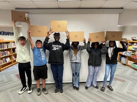 Whitman Middle School students who completed the Capital One Coders program are rewarded with computers.