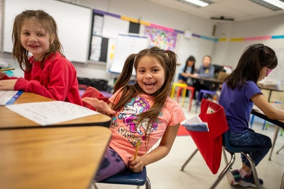 Students sitting at table in Kindergarten classroom