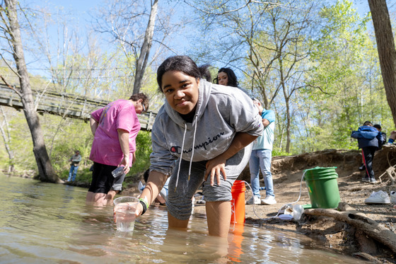 Student standing in stream