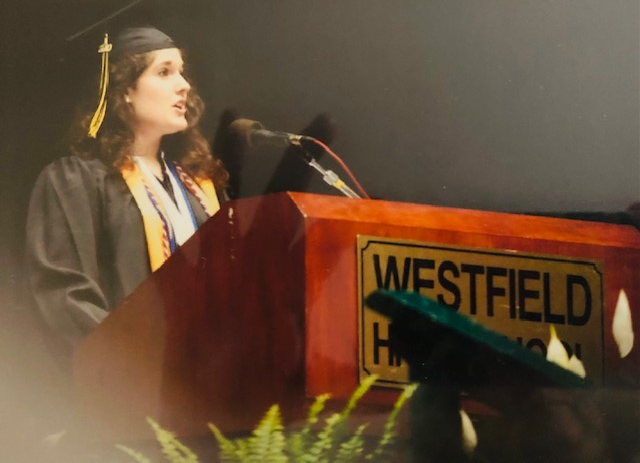 student gives graduation speech and podium