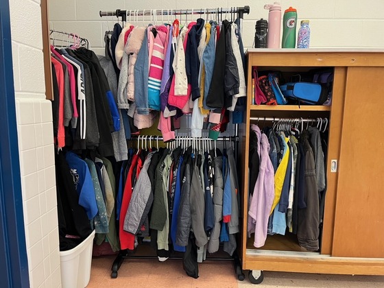 Coats and jackets organized in the Lost and Found of the cafeteria