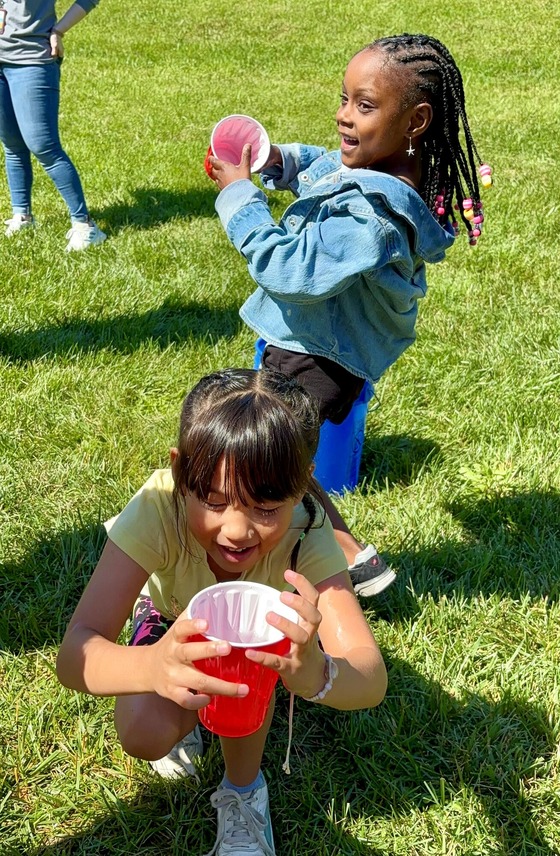 A student participates in a field day activity outdoors.