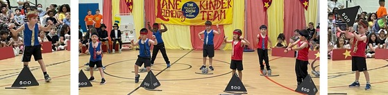 Students performing in the Kindergarten Circus - strongmen