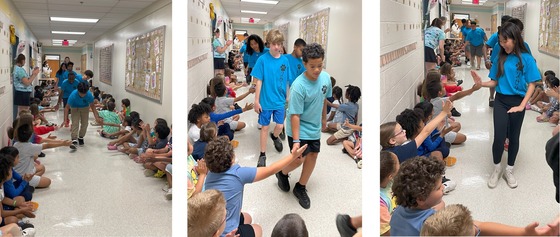 6th graders parading through the halls during a "clap out" by other students