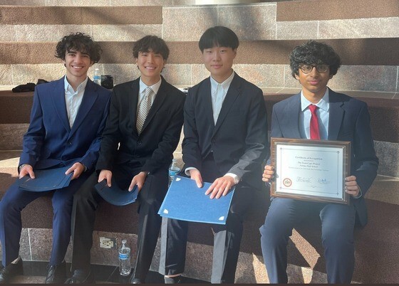 Students seating holding award