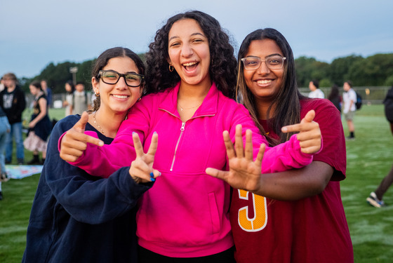 Woodson High School seniors hold up hands showing 2 and 5 fingers symbolizing the class of 2025