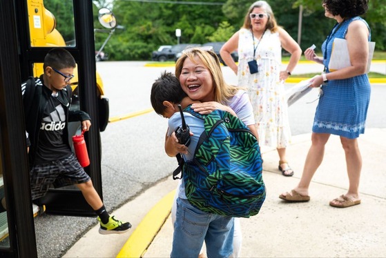 teacher hugs student