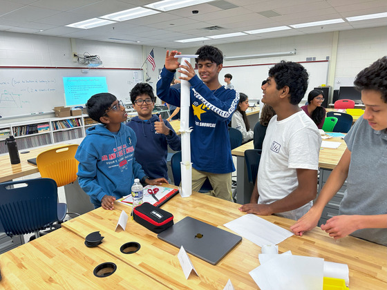 Students building a tall paper tower in Design and Technology