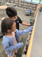 students looking at books