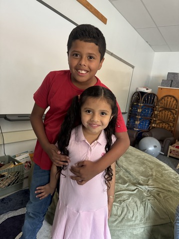 A student hugs his sister