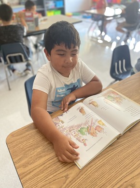 A young student reads a book 