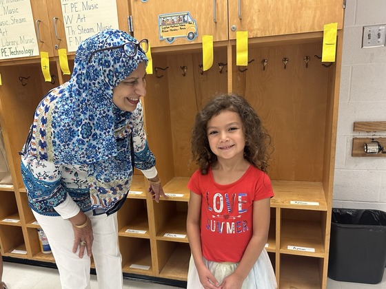 A photo of a child and an instructional assistant at last year's open house