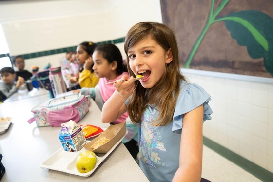 student eats food at lunch