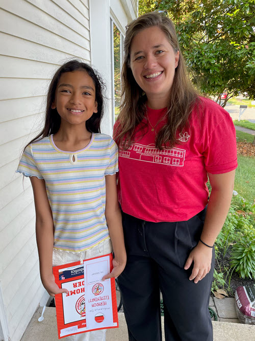 teacher with girl on steps