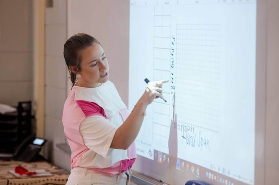 teacher writes on whiteboard