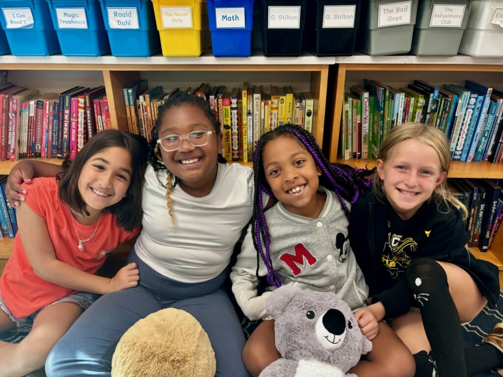 students sitting together with books