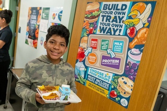 Student walking with lunch tray