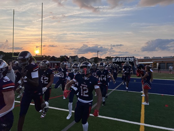 Football players running onto the field