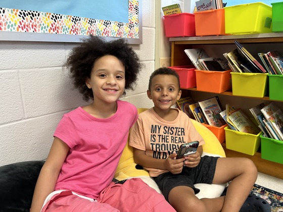 A brother and sister pictured smiling at Back to School Night