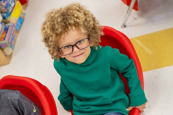 student smiling up at the camera