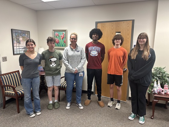 Five students standing with Mrs. Burke in an office