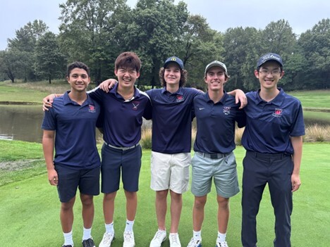 Golf members pose for picture on the golf course