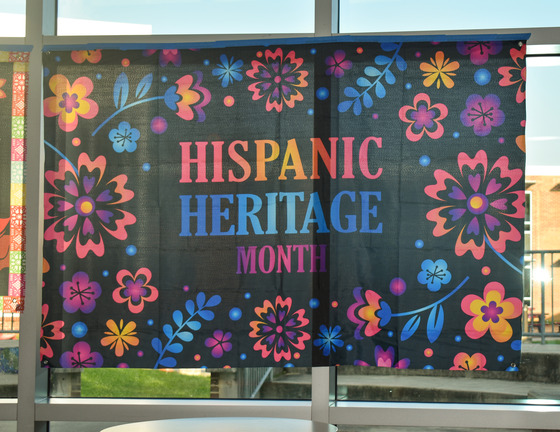 Hispanic Heritage Month sign hanging on window