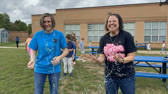 Principal and teacher being sprayed with Silly String