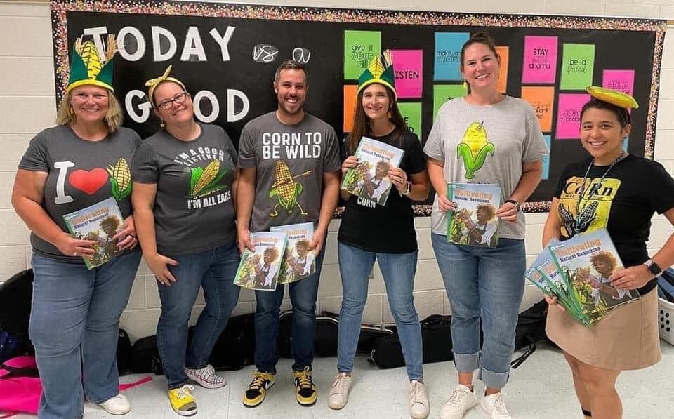 teachers smiling as their wear "corn" themed items