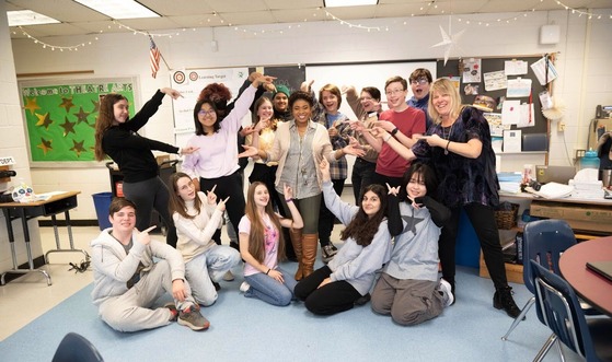 principal smiling with students