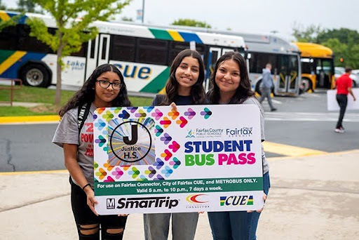 Three high school students holding up an oversized Student Bus Pass