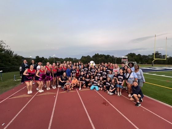 students and teachers standing on the track