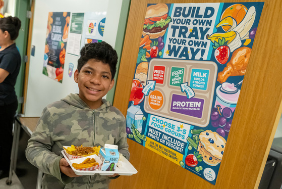 Students hold his school lunch 