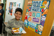 Student holding school lunch tray