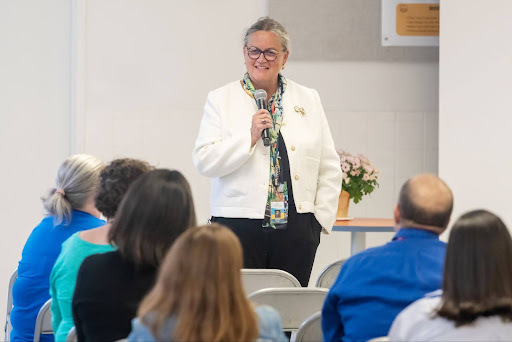 Dr. Reid speaking to an audience into a microphone